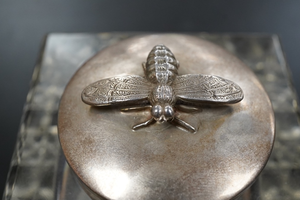 An Edwardian silver mounted clear glass inkwell, Birmingham, 1907, T Hazelwood & Co Ltd, square with hobnail cut base, the hinged mount with bee finial height 8.5cm